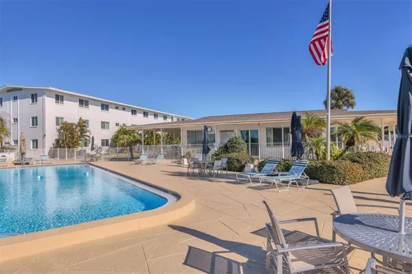 a view of swimming pool with outdoor seating and city view