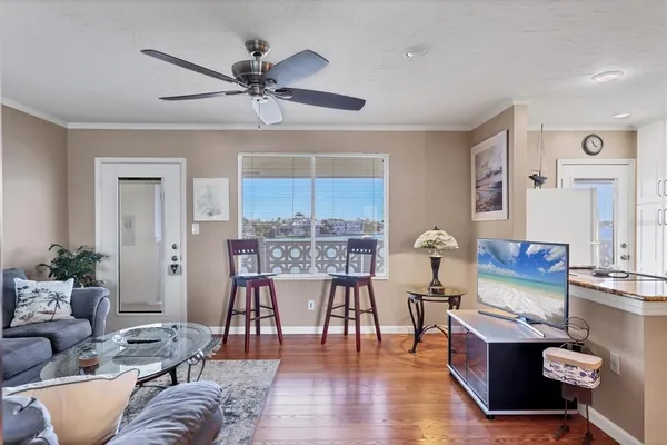 a living room with furniture and wooden floor
