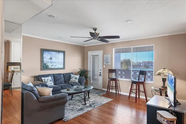 a living room with furniture and a wooden floor