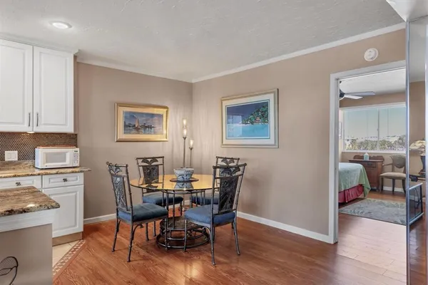 a view of a dining room with furniture and wooden floor