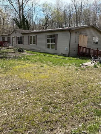 a house that has a tree in front of it