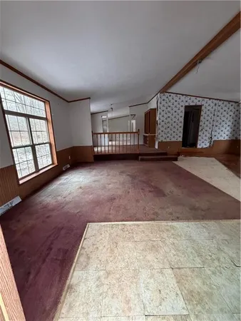 a view of an empty room with a fireplace and a window