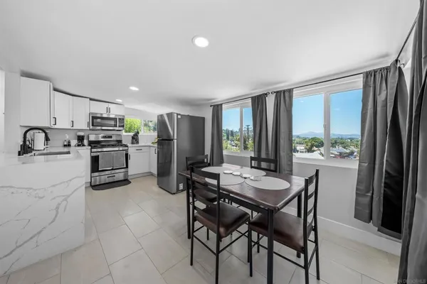 a kitchen with refrigerator cabinets and large window