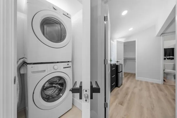 a view of a hallway with washer and dryer