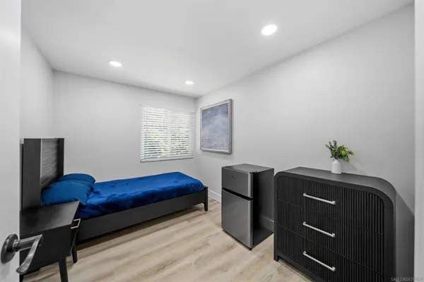 a bedroom with a bed and a dresser