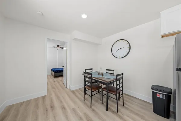 a view of a room that has a table and a chair in it