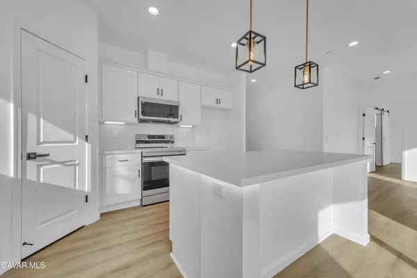 a kitchen with granite countertop a stove and a refrigerator