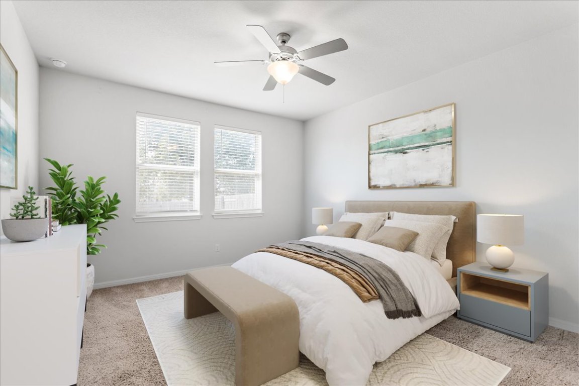 105 Otella Street Georgetown, TX 78628 - Photo 13 of 31 a bedroom with a bed and a potted plant