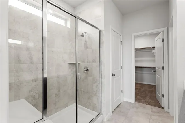 a bathroom with a glass shower door