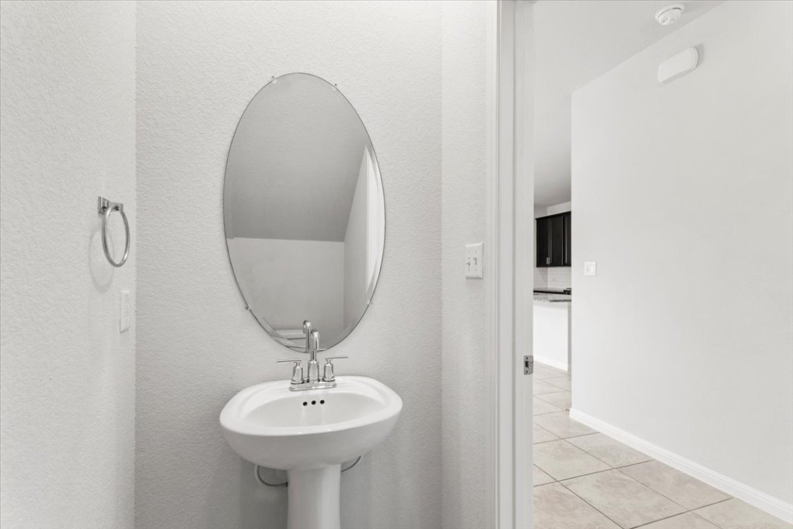 105 Otella Street Georgetown, TX 78628 - Photo 18 of 31 a bathroom with a sink and a mirror