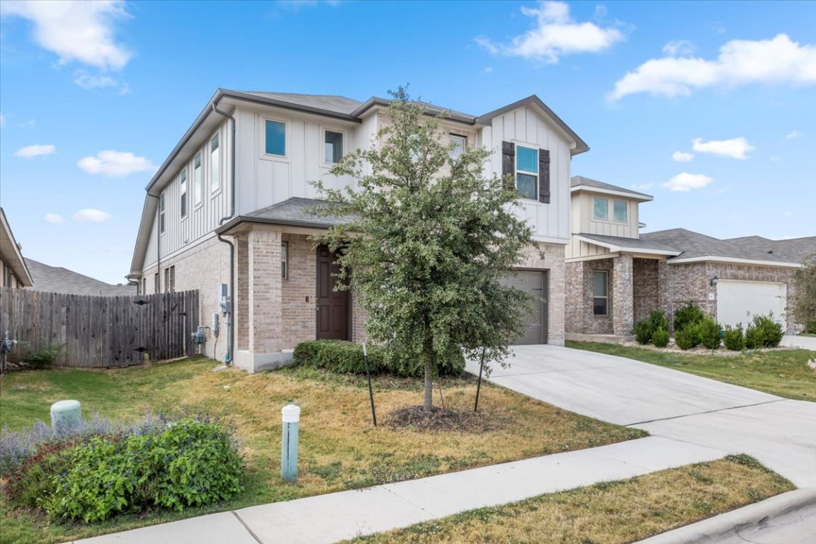 105 Otella Street Georgetown, TX 78628 - Photo 2 of 31 a front view of a house with garden
