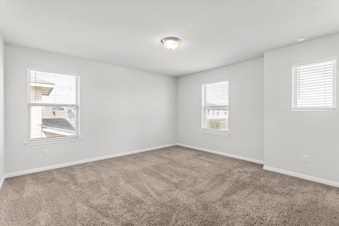 105 Otella Street Georgetown, TX 78628 - Photo 21 of 31 an empty room with windows