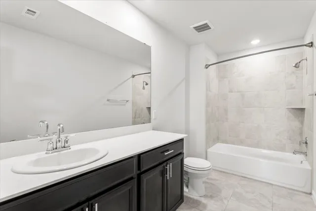 a bathroom with a granite countertop sink toilet a large mirror and shower