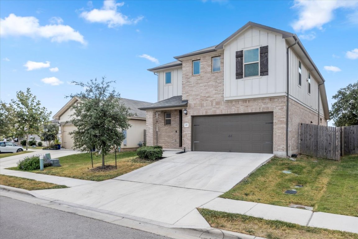 105 Otella Street Georgetown, TX 78628 - Photo 3 of 31 a front view of a house with a yard and garage