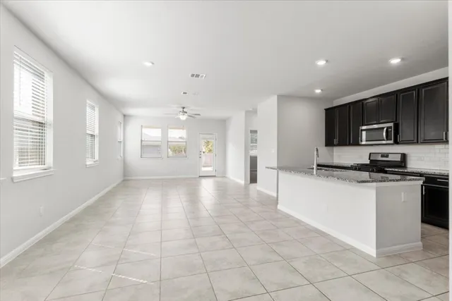 a view of a kitchen with a sink and a stove top oven