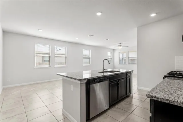 a kitchen with stainless steel appliances granite countertop a sink and a stove