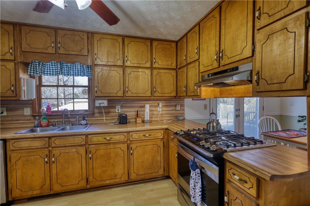 12510 Highway 36 Covington, GA 30014 - Photo 11 of 31 a kitchen with stainless steel appliances granite countertop a stove and a sink