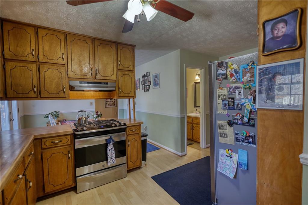 12510 Highway 36 Covington, GA 30014 - Photo 10 of 31 a kitchen with stainless steel appliances granite countertop a stove and a refrigerator