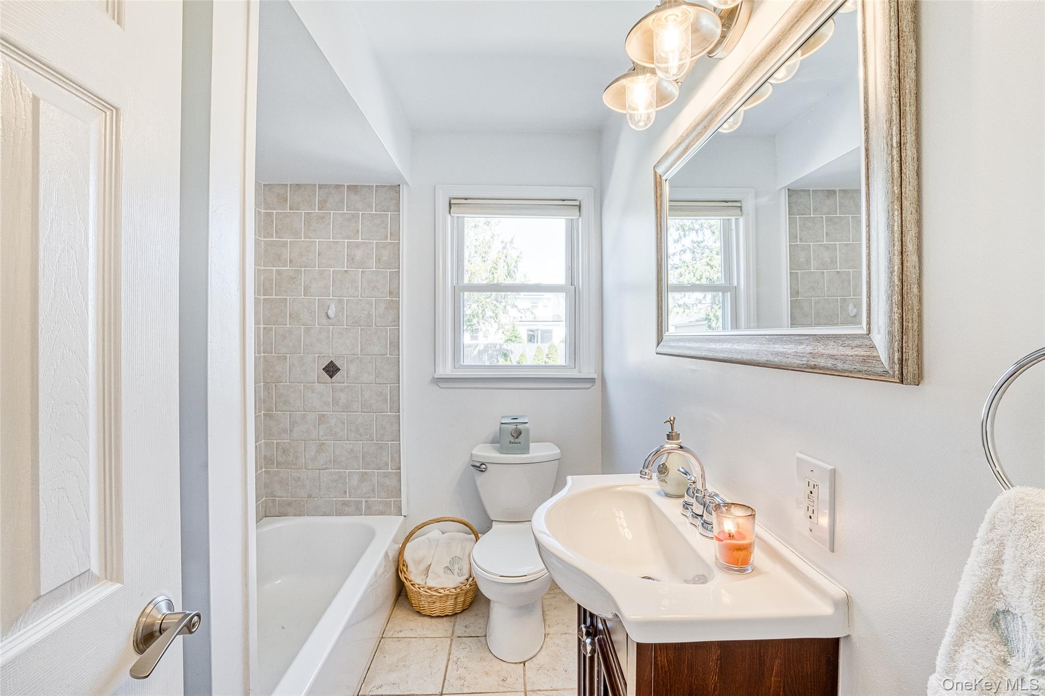 210 11th Street West Babylon, NY 11704 - Photo 12 of 36 a bathroom with a sink a tub and a mirror