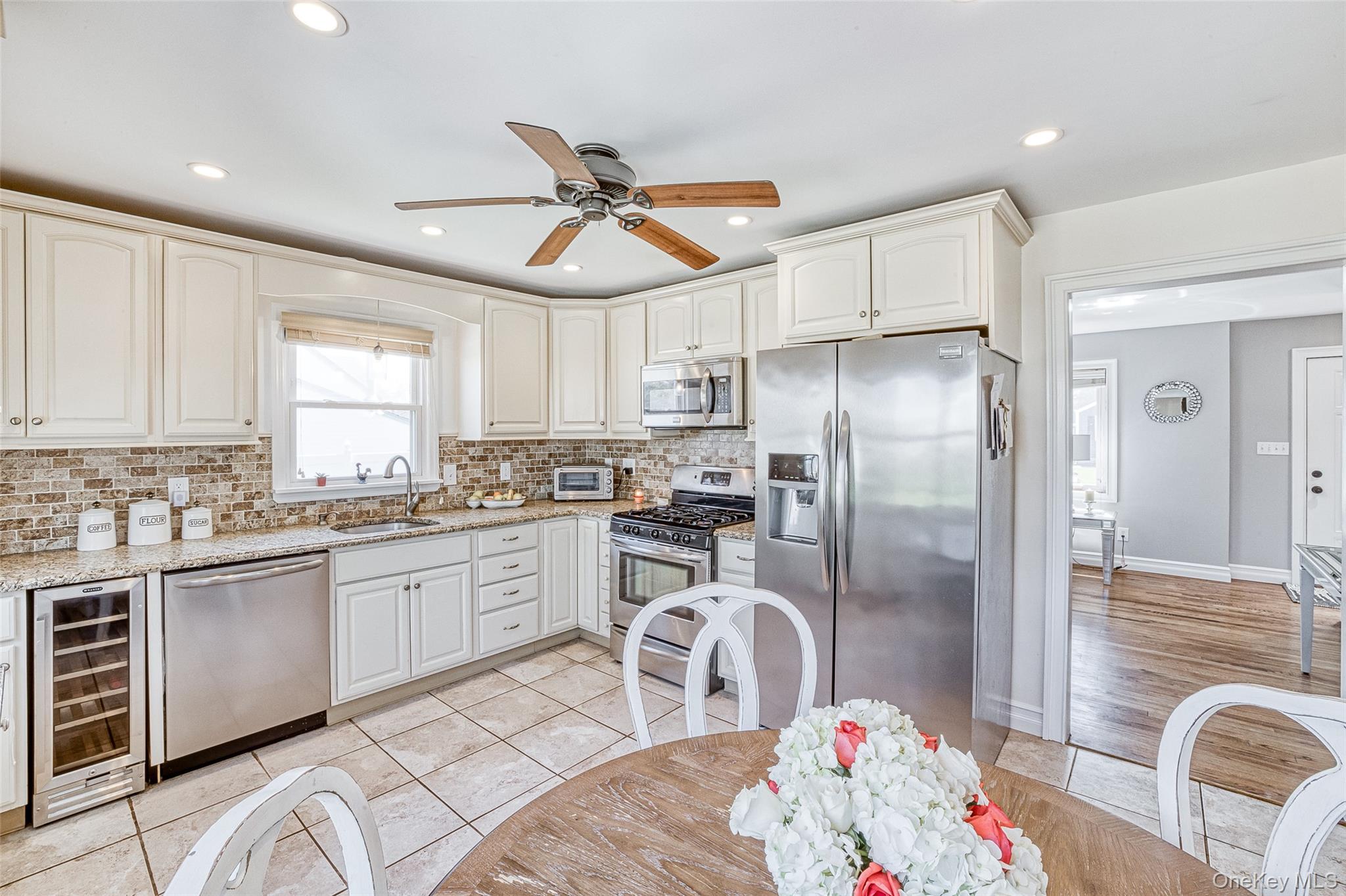 210 11th Street West Babylon, NY 11704 - Photo 18 of 36 a kitchen with a refrigerator and a sink