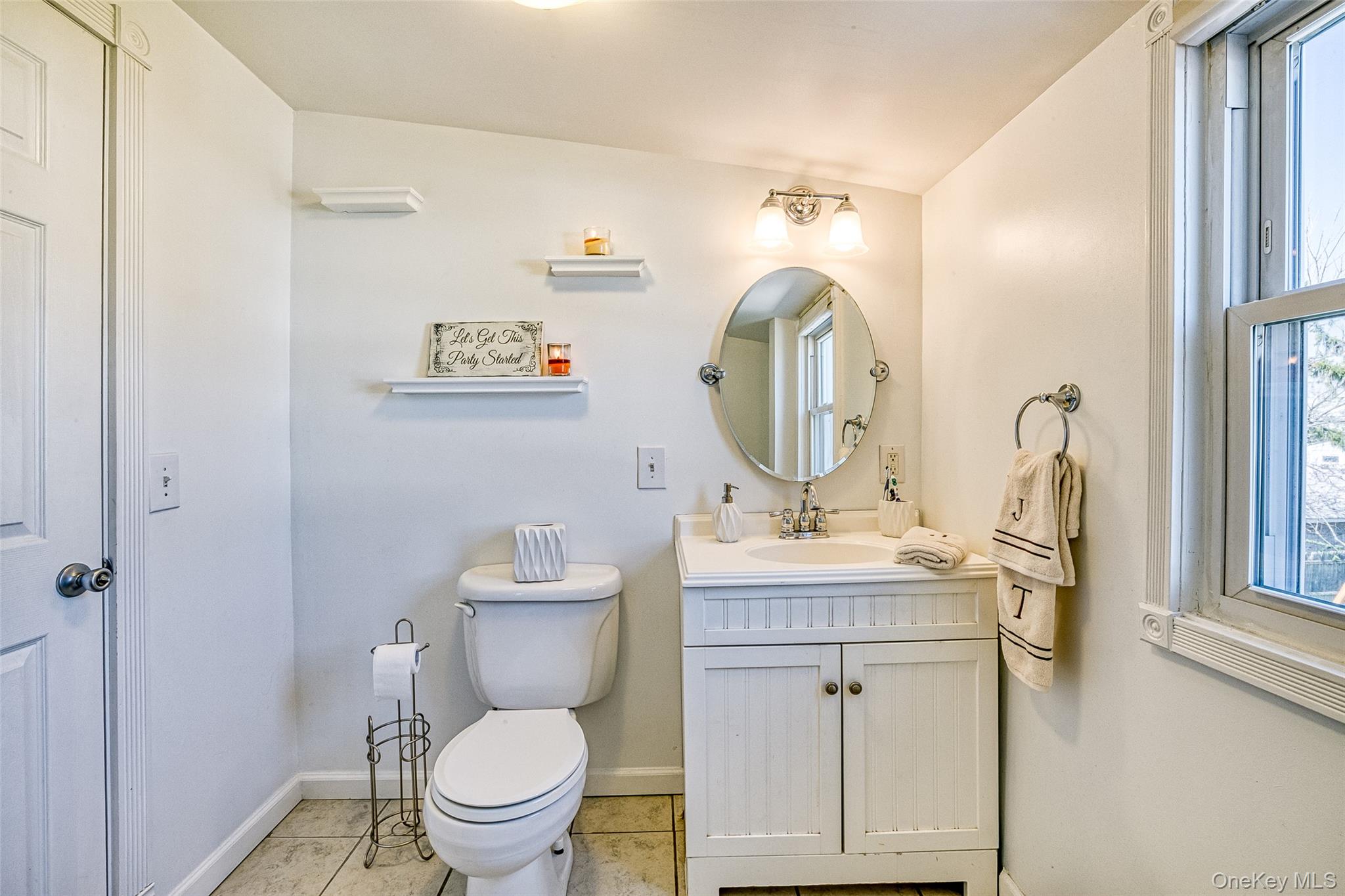 210 11th Street West Babylon, NY 11704 - Photo 23 of 36 a bathroom with a toilet a sink and a mirror