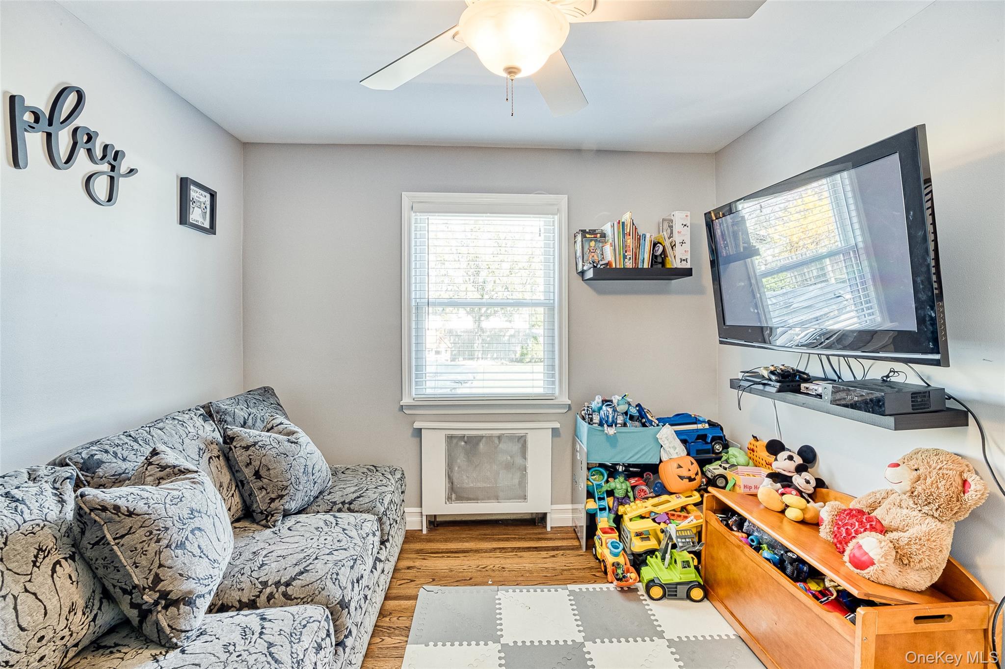 210 11th Street West Babylon, NY 11704 - Photo 24 of 36 a bedroom with furniture and a flat screen tv
