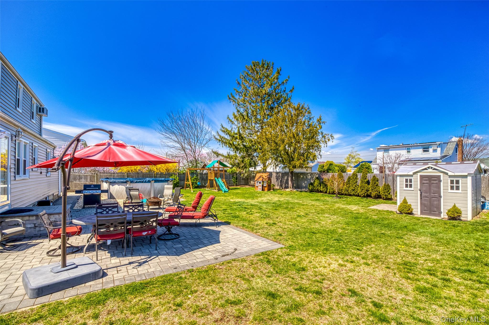 210 11th Street West Babylon, NY 11704 - Photo 31 of 36 a view of a house with swimming pool and sitting area