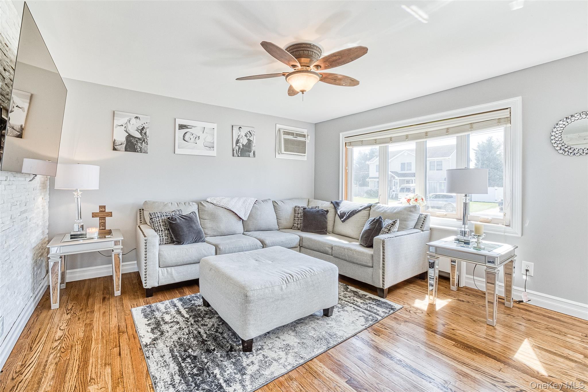 210 11th Street West Babylon, NY 11704 - Photo 4 of 36 a living room with furniture and a large window with wooden floor