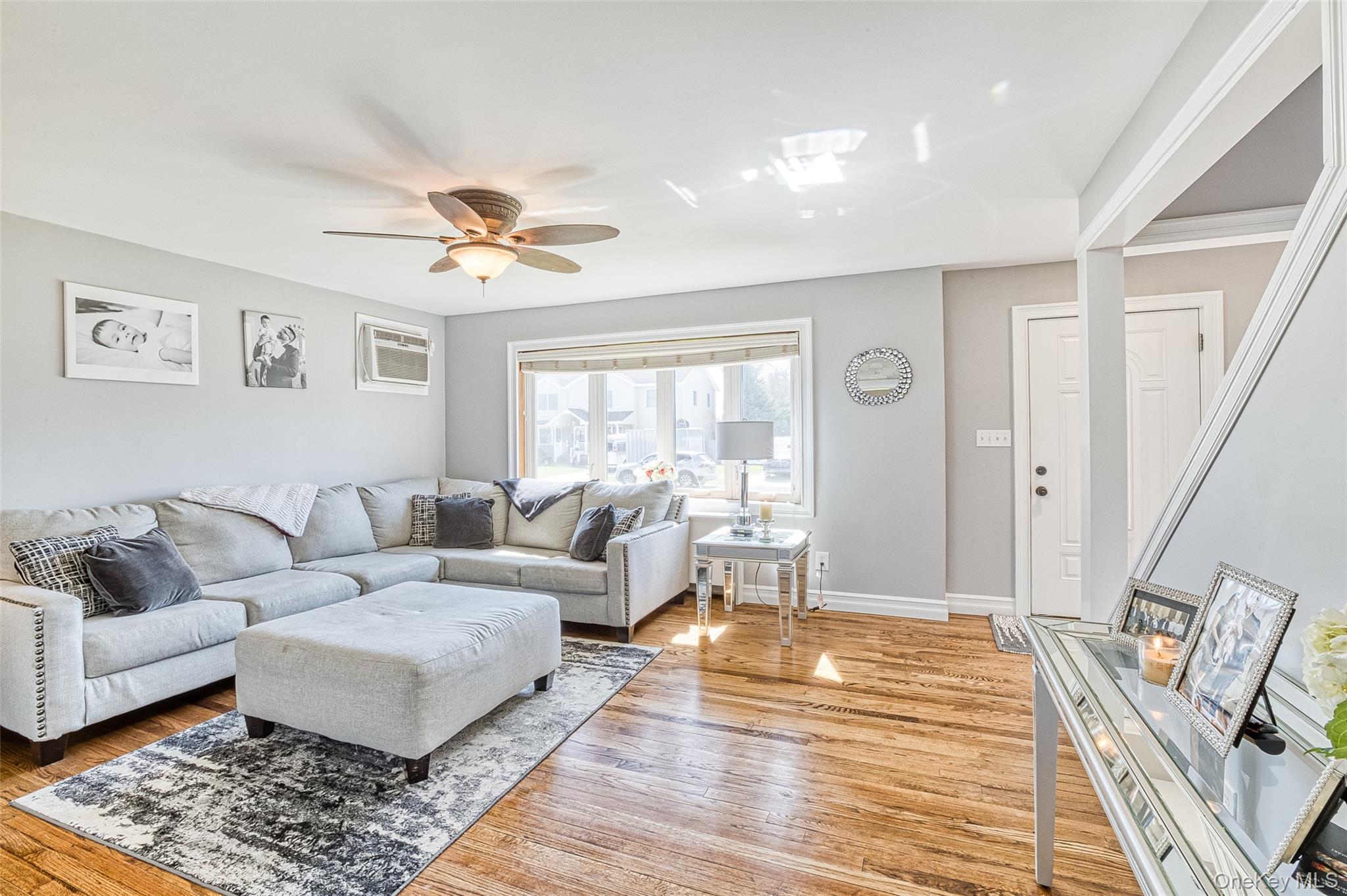 210 11th Street West Babylon, NY 11704 - Photo 7 of 36 a living room with furniture and a rug