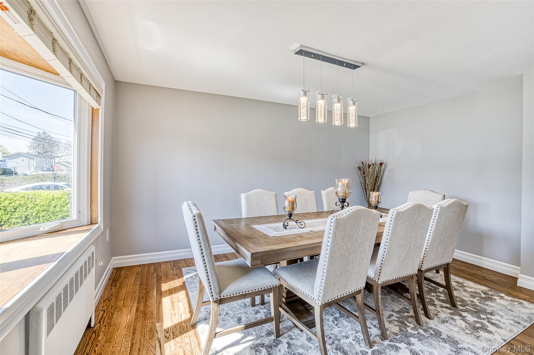 210 11th Street West Babylon, NY 11704 - Photo 8 of 36 a view of a dining room with furniture a chandelier and wooden floor