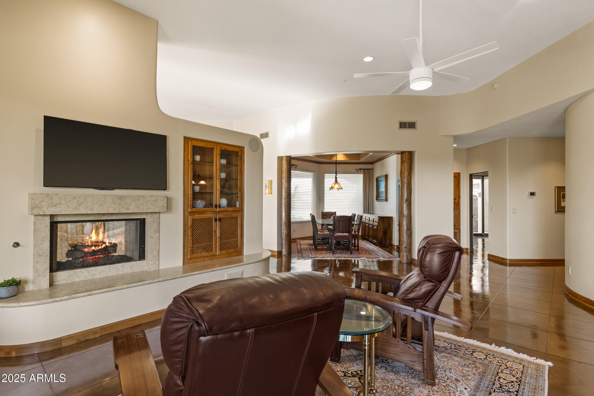 36663 Wild Flower Road Carefree, AZ 85377 - Photo 24 of 79 a living room with furniture a flat screen tv and a fireplace