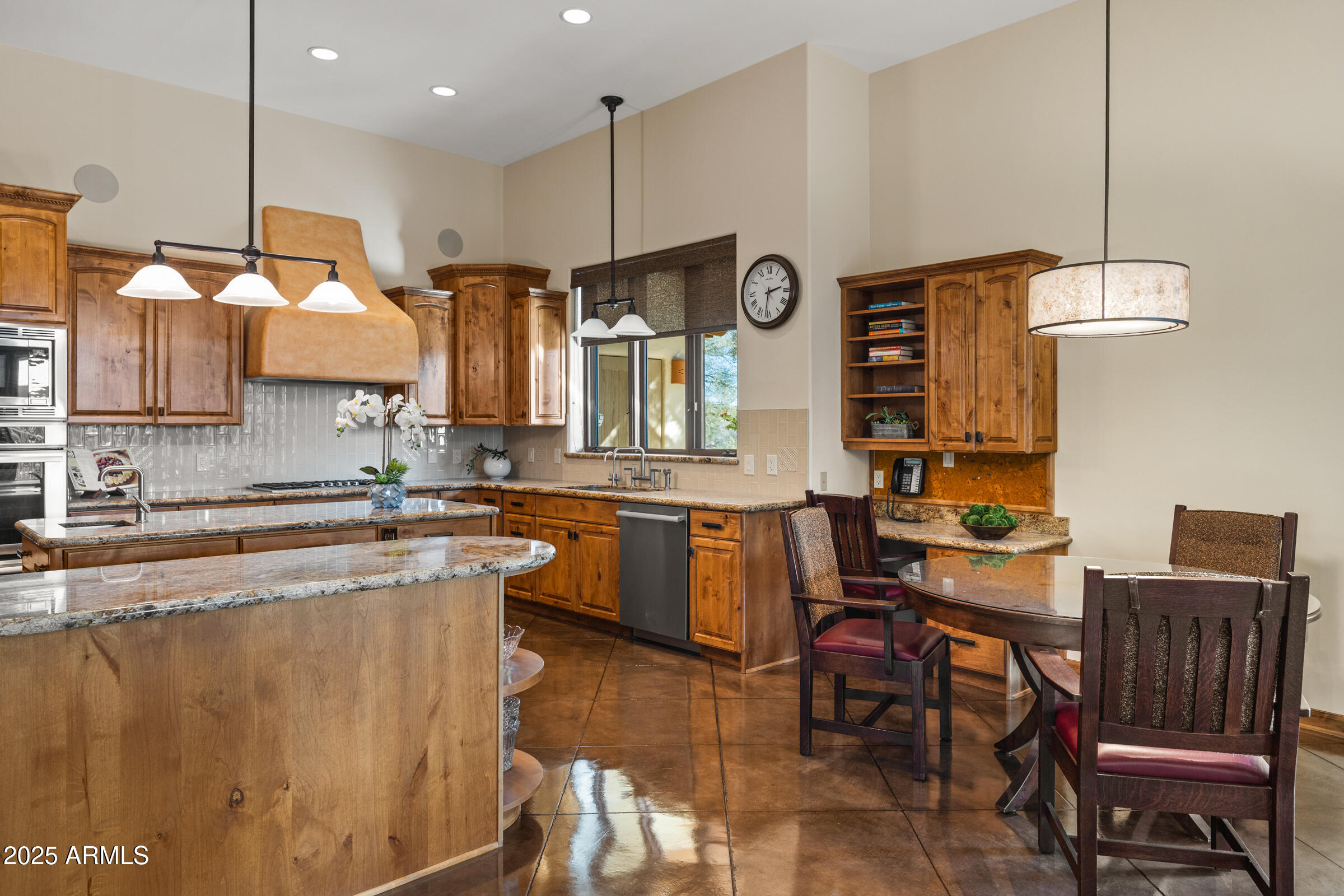 36663 Wild Flower Road Carefree, AZ 85377 - Photo 26 of 79 a large kitchen with a table and chairs in it