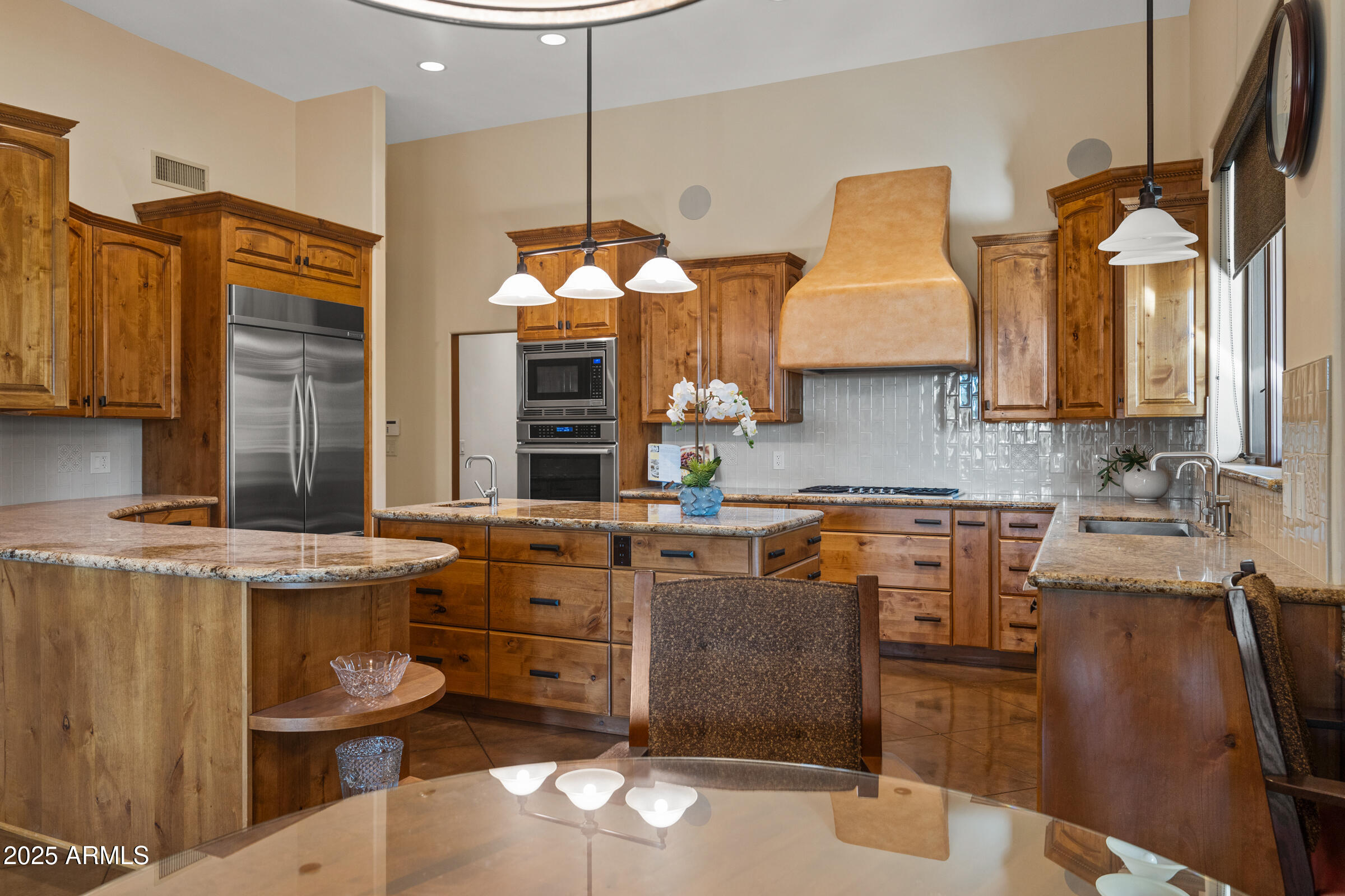 36663 Wild Flower Road Carefree, AZ 85377 - Photo 27 of 79 a kitchen with stainless steel appliances granite countertop a sink a stove and a wooden cabinets