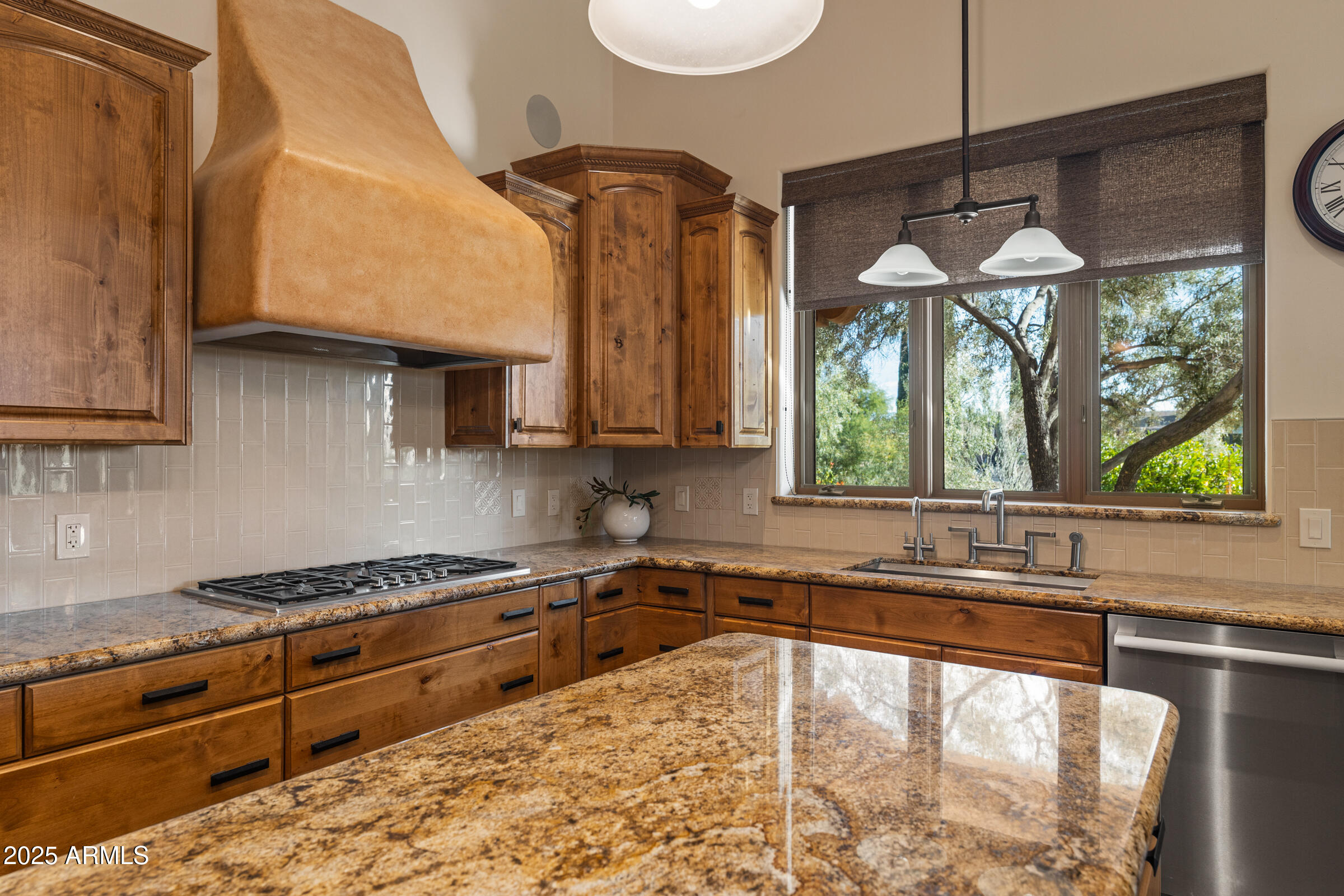 36663 Wild Flower Road Carefree, AZ 85377 - Photo 32 of 79 a kitchen with stainless steel appliances granite countertop a stove a sink and a microwave