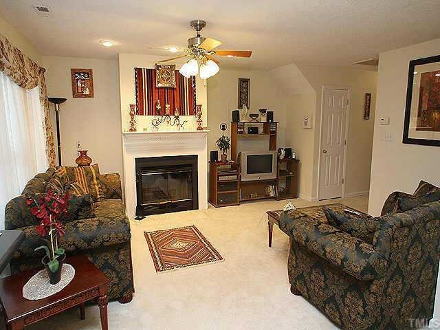 6704 Twin Tree Court Raleigh, NC 27613 - Photo 3 of 11 The large living room is light & bright & features a wood-burning fireplace & ceiling fan. It is open to the dining room and eat-in kitchen Other