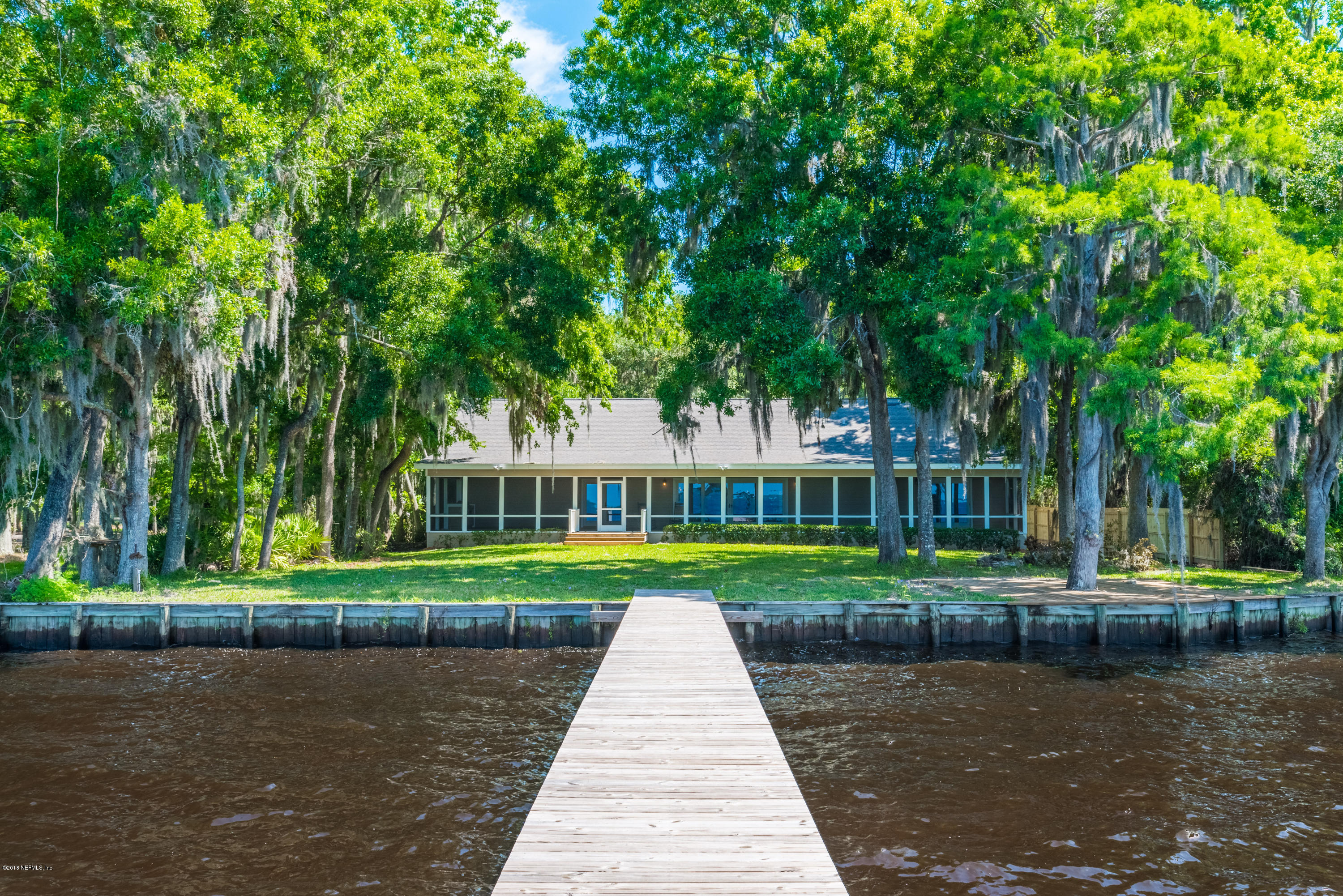 7867 Rusty Anchor Road St. Augustine, FL 32092 - Photo 5 of 36 a front view of a house with a yard and trees