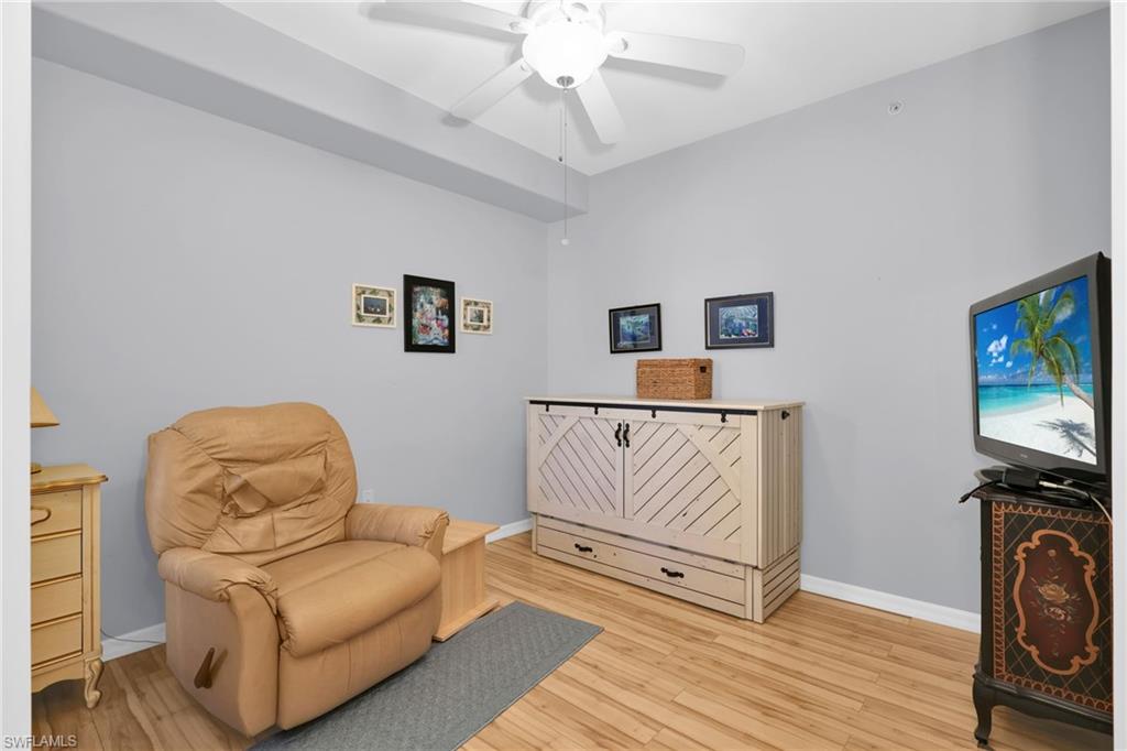 1435 Tiffany Lane, Unit 302 Naples, FL 34105 - Photo 14 of 36 a living room with furniture and a flat screen tv