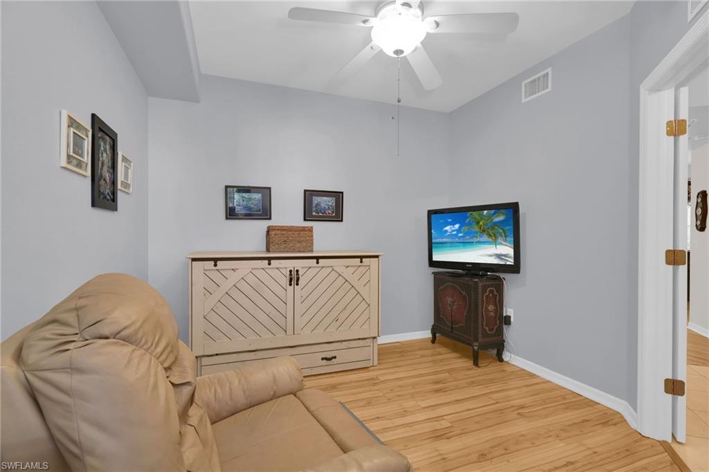 1435 Tiffany Lane, Unit 302 Naples, FL 34105 - Photo 15 of 36 a bedroom with a bed and a flat screen tv