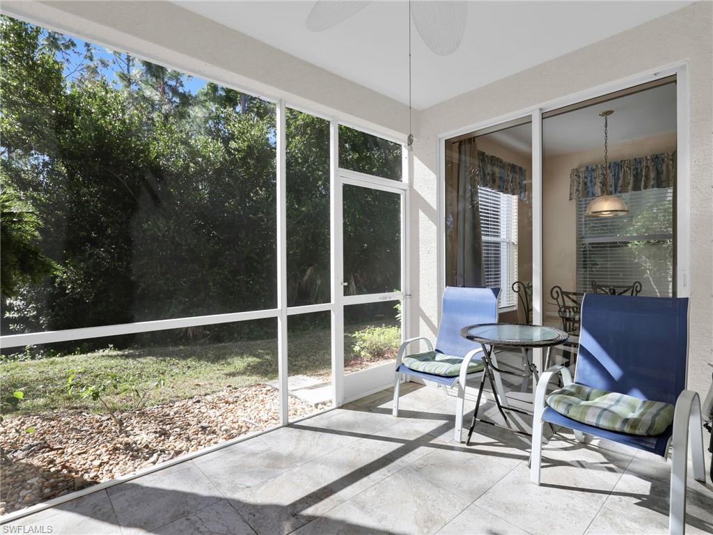 1435 Tiffany Lane, Unit 302 Naples, FL 34105 - Photo 17 of 36 a view of chair and tables in the patio