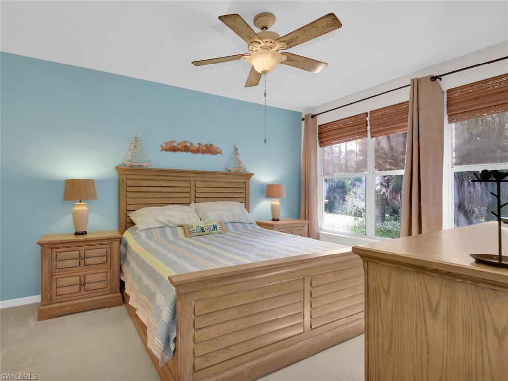 1435 Tiffany Lane, Unit 302 Naples, FL 34105 - Photo 19 of 36 a bedroom with a bed and a dresser next to a window