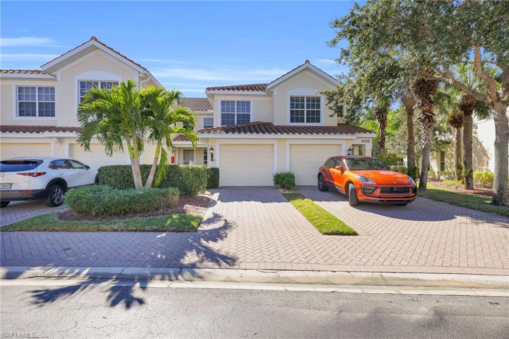 1435 Tiffany Lane, Unit 302 Naples, FL 34105 - Photo 2 of 36 a house view with a garden space