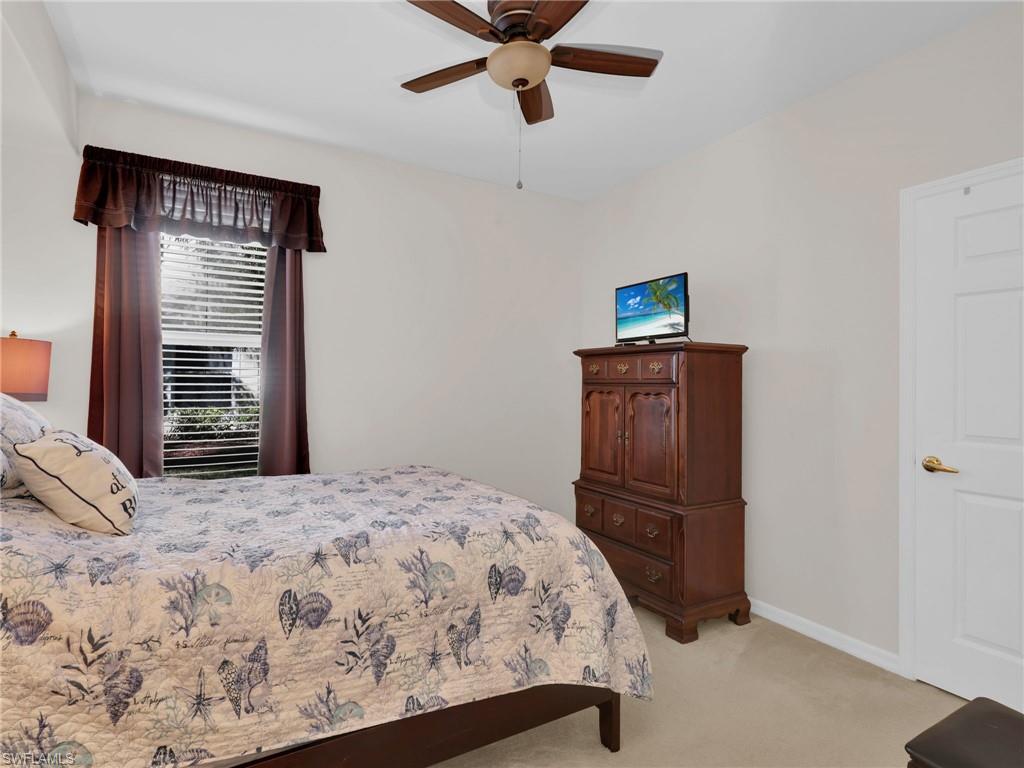 1435 Tiffany Lane, Unit 302 Naples, FL 34105 - Photo 23 of 36 a bedroom with a bed and a window