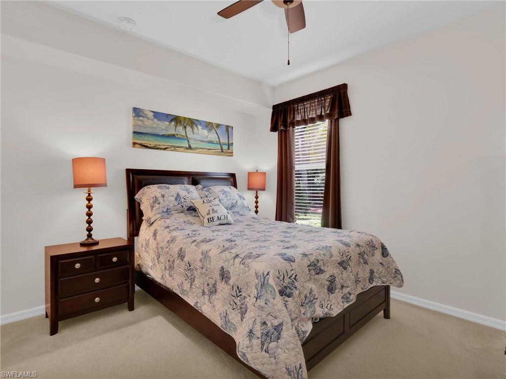 1435 Tiffany Lane, Unit 302 Naples, FL 34105 - Photo 24 of 36 a bedroom with a bed and window