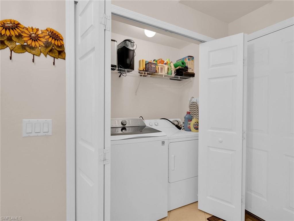 1435 Tiffany Lane, Unit 302 Naples, FL 34105 - Photo 26 of 36 a view of storage and utility room with washer and dryer