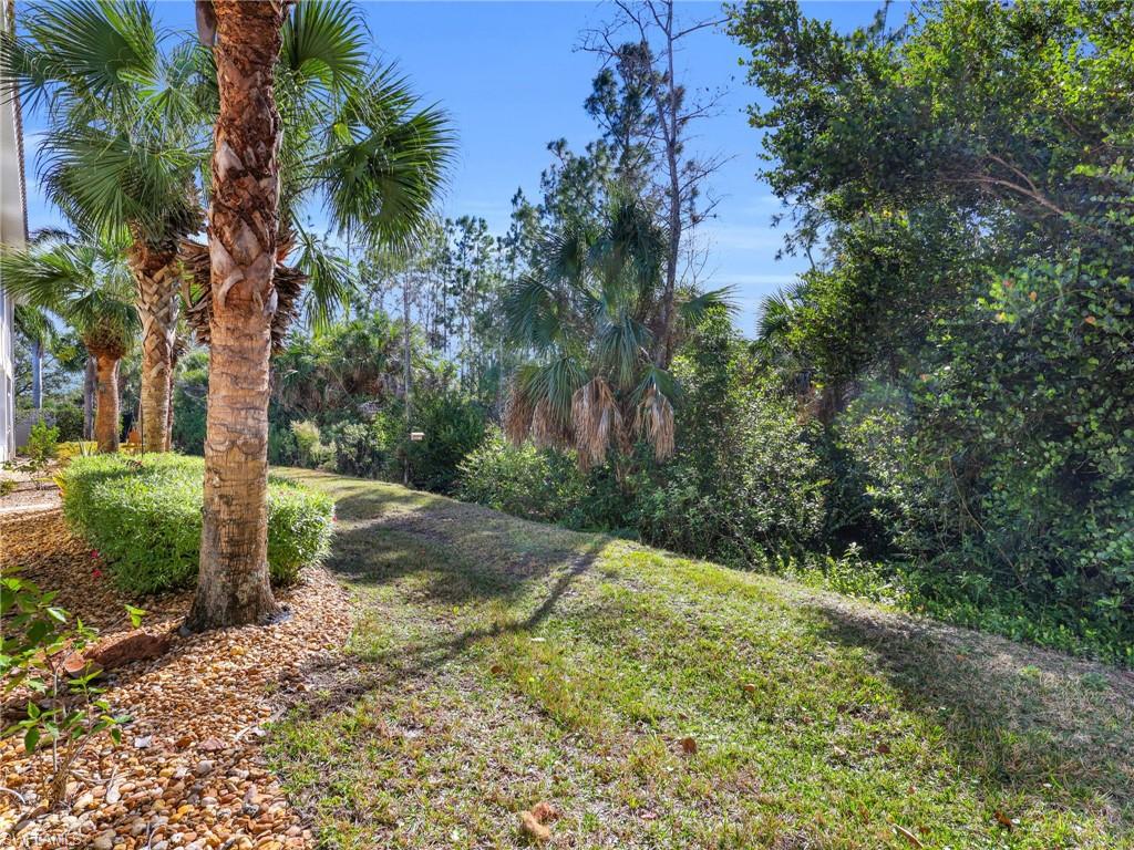 1435 Tiffany Lane, Unit 302 Naples, FL 34105 - Photo 28 of 36 a view of a yard with plants and trees