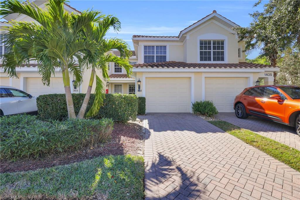 1435 Tiffany Lane, Unit 302 Naples, FL 34105 - Photo 29 of 36 a front view of a house with garden