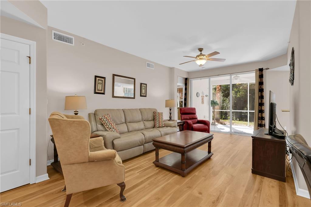 1435 Tiffany Lane, Unit 302 Naples, FL 34105 - Photo 3 of 36 a living room with furniture and a large window