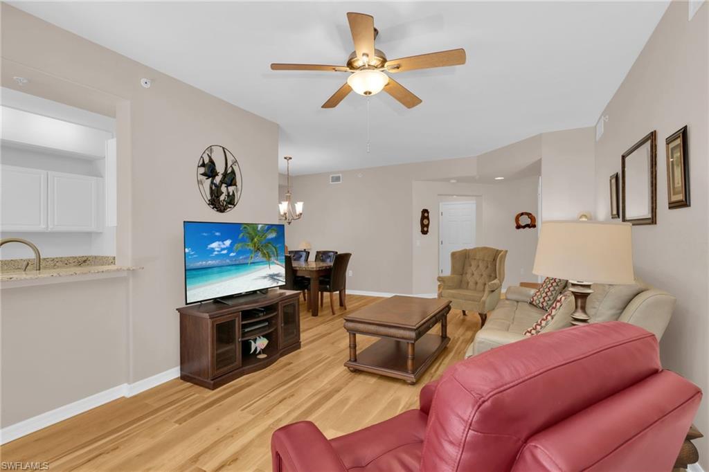 1435 Tiffany Lane, Unit 302 Naples, FL 34105 - Photo 7 of 36 a view of a livingroom with furniture and a flat screen tv