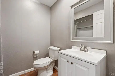 a bathroom with a sink toilet and a mirror