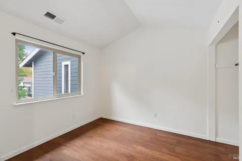 a wooden fence and trees in the background